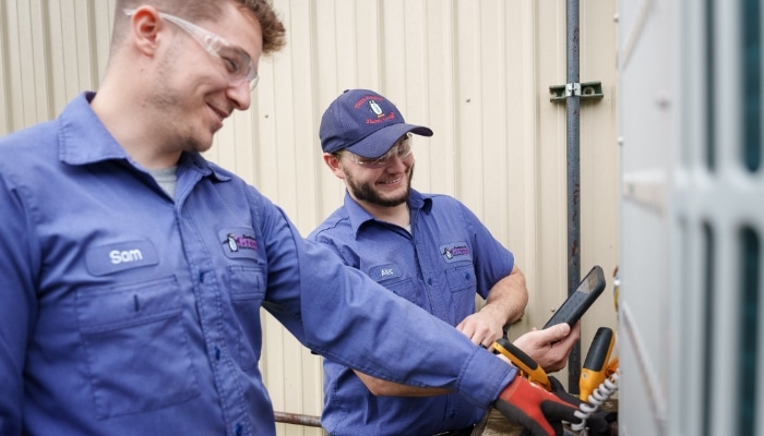 Two Techniciancs Performing Work On Hvac